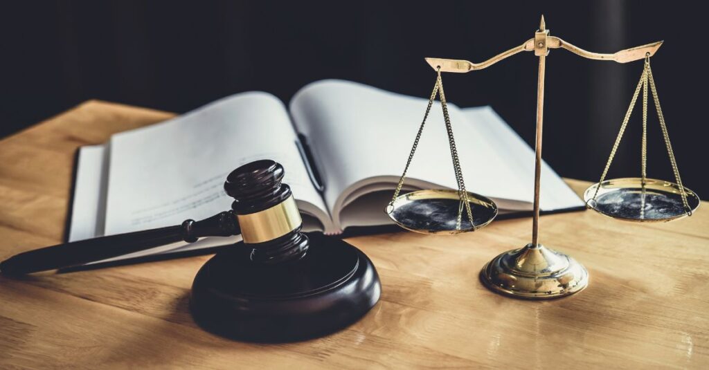 Scales of justice with gavel and open book